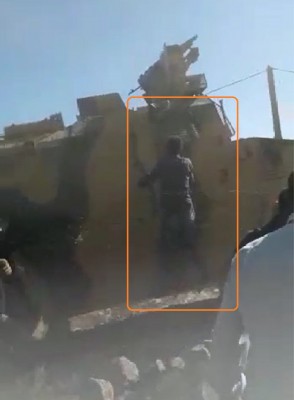 a_bare_handed_civilian_protester_tries_to_get_on_a_turkish_military_vehicle_as_if_he_wanted_to_speak_at_the_drivers_window_who_accelerates_and_drives_off_obs._av__ef_scr.shot_400